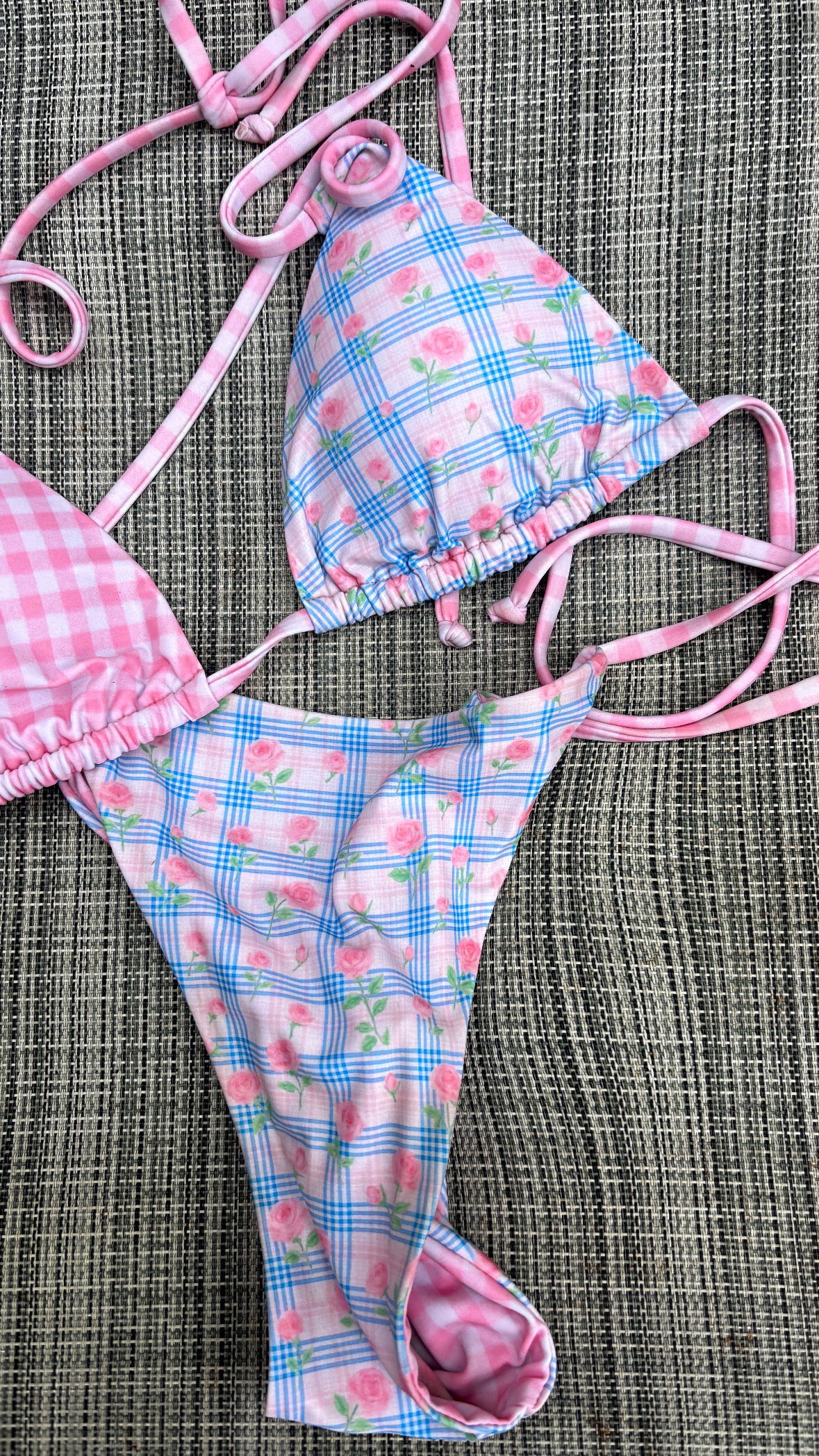 Reversible picnic bikini by Zana Gorman: baby blue gingham front, tiny rose print reverse, tied bows, relaxed beach scene.