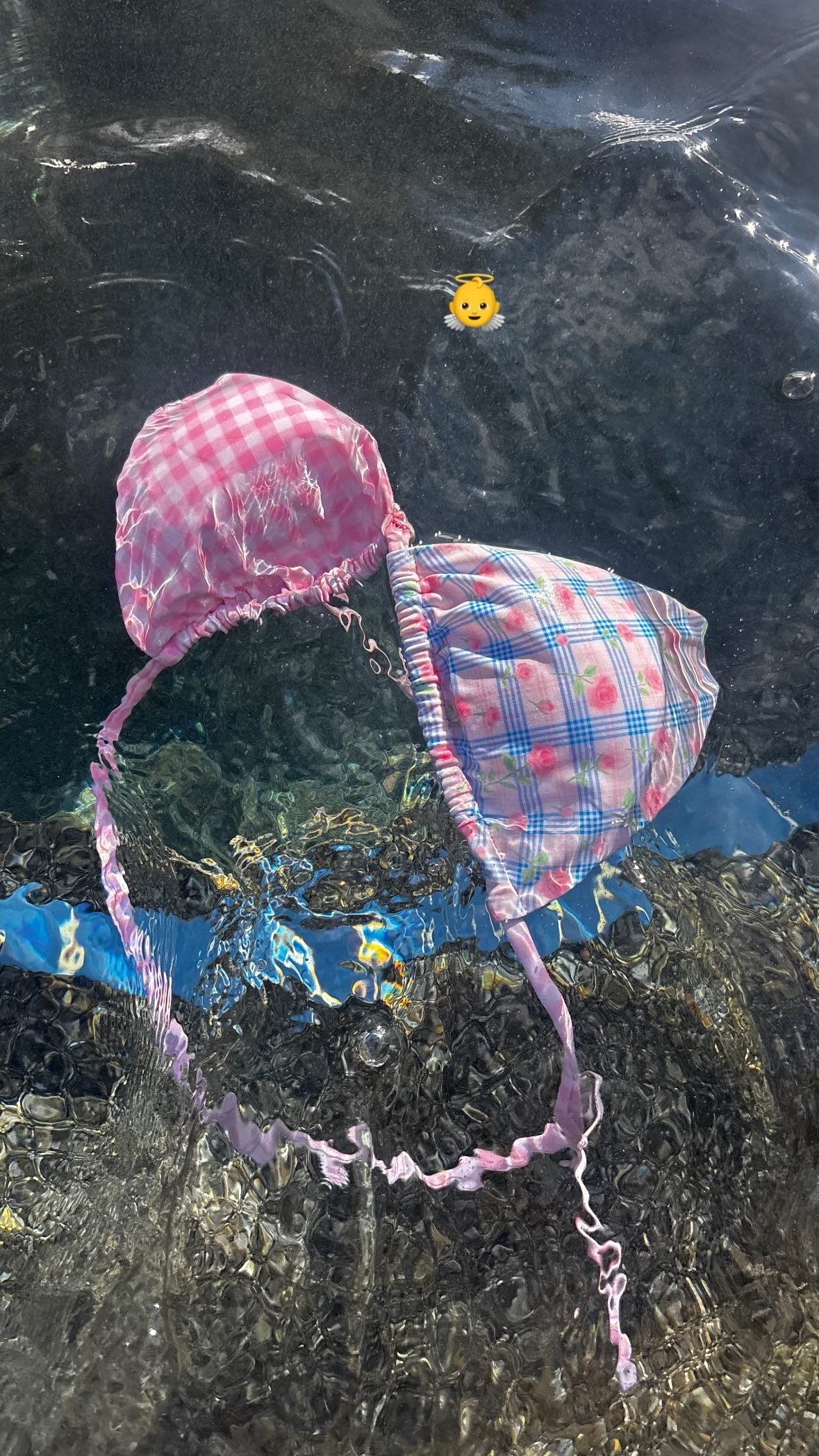 Reversible picnic bikini by Zana Gorman: baby blue gingham front, tiny rose print reverse, tied bows, relaxed beach scene.